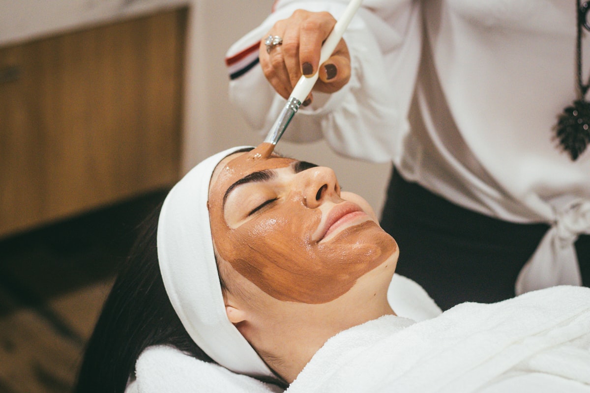 A practitioner giving a calm, considered facial treatment