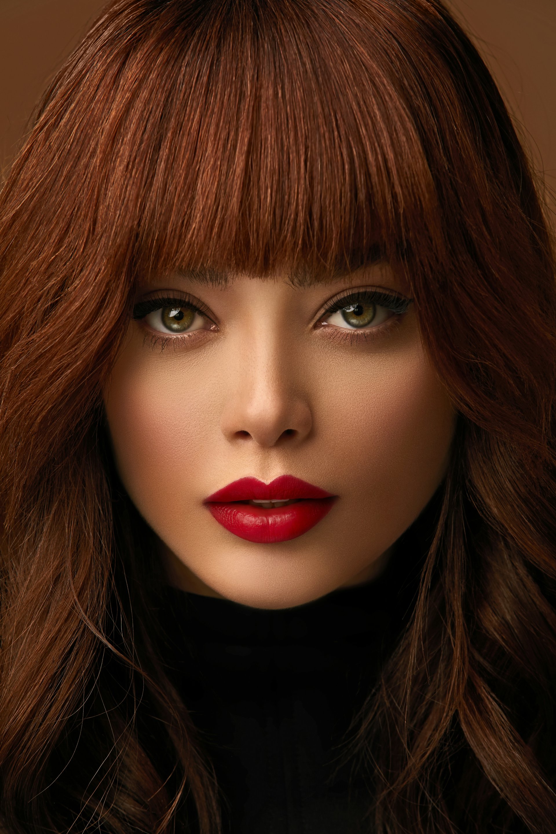 Editorial beauty portrait with a bold red lip, in warm cinematic light